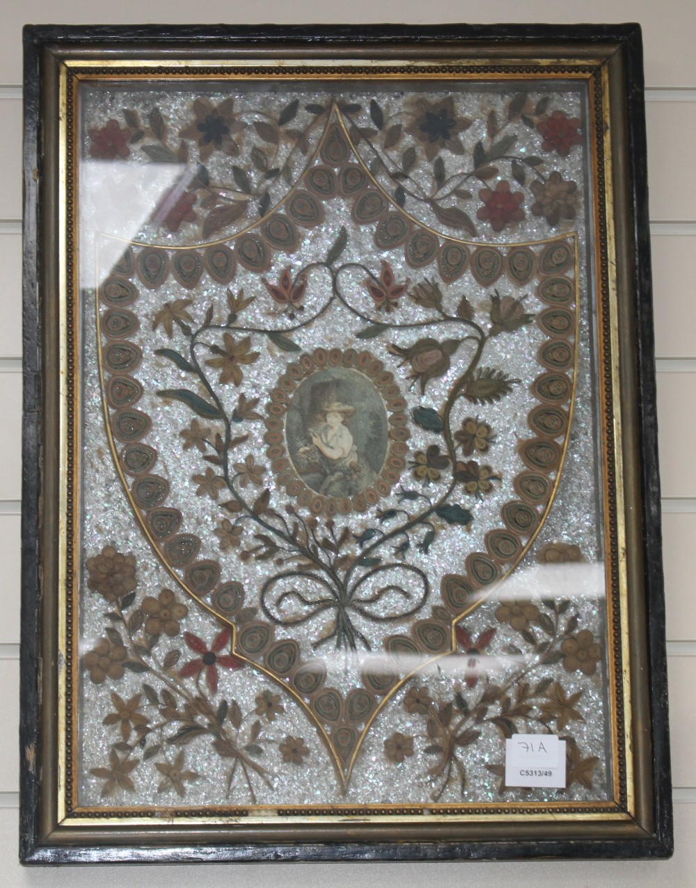 An early 19th century paper scroll work panel